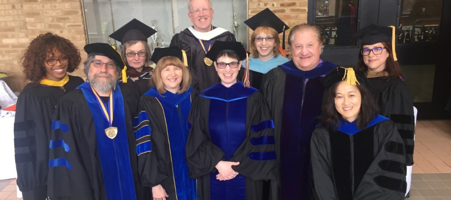 Communication Department faculty wearing regalia at commencement