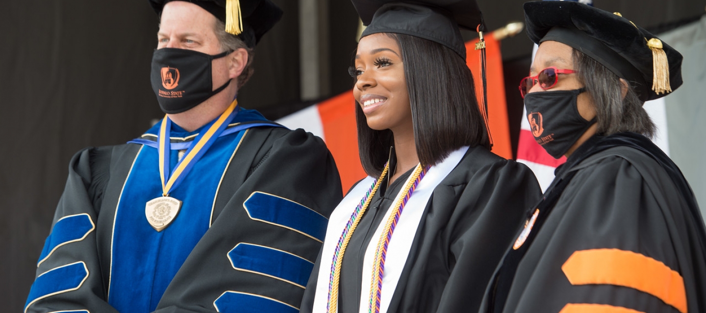 Students and faculty in graduation regalia