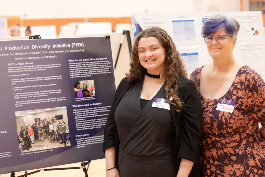 Faculty stand next to poster presentation