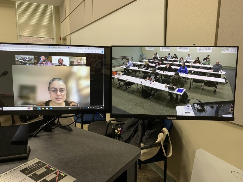 Computer monitors showing online meeting